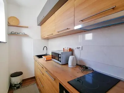 a kitchen with a microwave on a wooden counter at Apartman Andjelkovic in Soko Banja