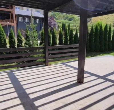 a wooden porch with a fence and trees at Gondola Studio Brzeće Kopaonik in Brzeće