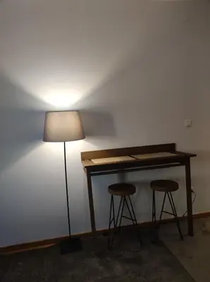 a desk with two stools next to a lamp at Gondola Studio Brzeće Kopaonik in Brzeće