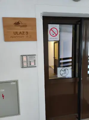a door to a building with a sign on it at Gondola Studio Brzeće Kopaonik in Brzeće