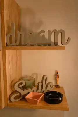 a wooden shelf with a sign that reads asylum at Apartman Sen's in Leskovac