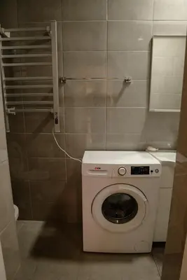 a small bathroom with a washing machine in it at Apartman Sen's in Leskovac