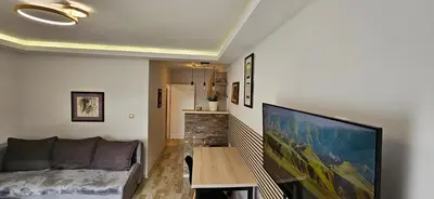 a living room with a couch and a table at Apartman Sen's in Leskovac