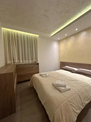 a bedroom with a large bed and a window at MB Apartmani Kopaonik in Kopaonik