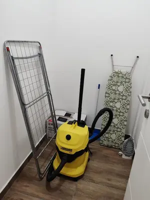a yellow vacuum on the floor next to a metal detector at APARTMAN ANDREA in Leskovac