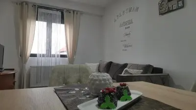 a living room with a table with two cakes on it at APARTMAN ANDREA in Leskovac