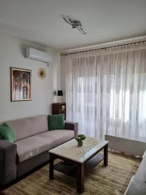 a living room with a couch and a coffee table at Apartman Nevena in Vrnjačka Banja