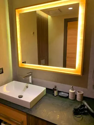 a bathroom with a white sink and a large mirror at Woodside Kopaonik - Malo jezero, FREE Parking & SPA in Kopaonik