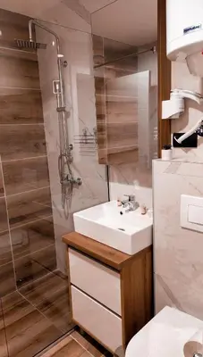 a bathroom with a sink and a shower at Lukić Apartmani in Kopaonik