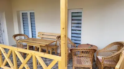 a wooden table and chairs on a porch at ETNO Selo STRAŽA in Pirot
