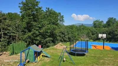 a playground with play equipment in a field at ETNO Selo STRAŽA in Pirot