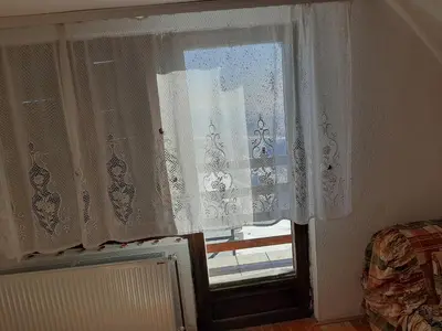 a window with white curtains in a room at Vikend kuća Vukašinović in Kopaonik