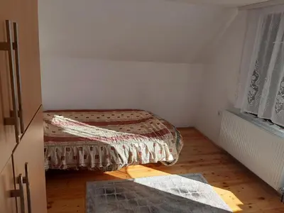 a small bedroom with a bed and a window at Vikend kuća Vukašinović in Kopaonik