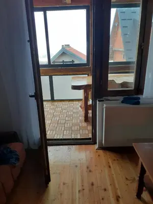 an open door to a room with a view of a kitchen at Vikend kuća Vukašinović in Kopaonik