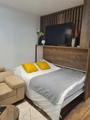 a bedroom with a bed and a flat screen tv at Dajoda Lux - free Spa in Kopaonik