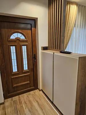 a kitchen with a refrigerator and a wooden door at Dajoda Lux - free Spa in Kopaonik