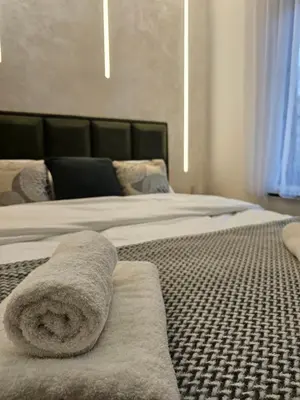 two beds with towels on them in a bedroom at Dajoda Lux - free Spa in Kopaonik