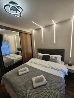 a bedroom with a bed with two towels on it at Dajoda Lux - free Spa in Kopaonik
