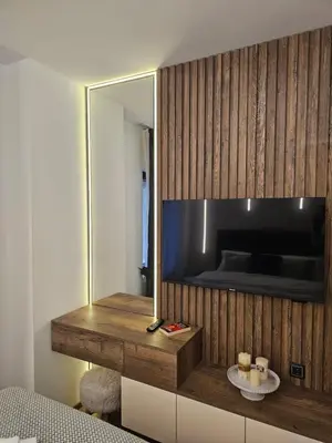 a room with a mirror and a television on a wall at Dajoda Lux - free Spa in Kopaonik