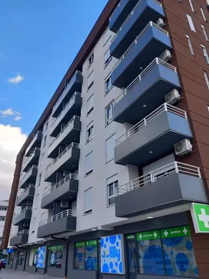 an apartment building with balconies on the side of it at Apartman Petra in Niš