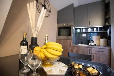 a table with a bowl of bananas and wine bottles at Velickovic Alibi in Kopaonik
