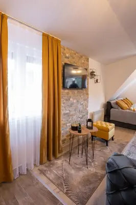 a living room with a couch and a table at Velickovic Alibi in Kopaonik