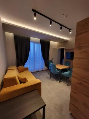 a living room with a couch and a table at Three Pearls in Kopaonik