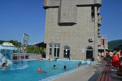 a group of people swimming in a swimming pool at Sokoterme Hotel in Soko Banja