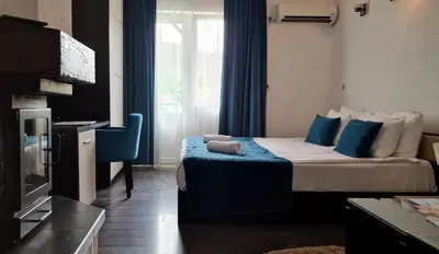 a hotel room with a bed and a television at Sokoterme Hotel in Soko Banja