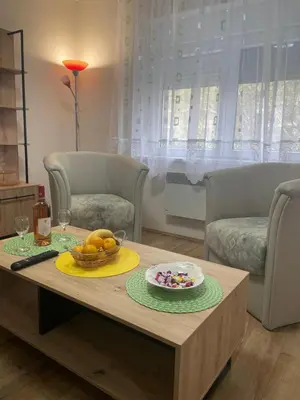 a living room with a table with a bowl of fruit at Konstantin Sokobanja in Soko Banja