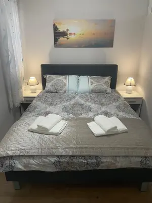 a bedroom with a bed with two towels on it at Konstantin Sokobanja in Soko Banja