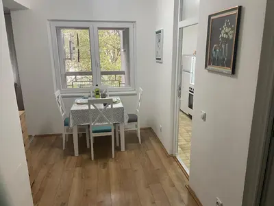 a dining room with a table and chairs and a window at Konstantin Sokobanja in Soko Banja