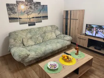 a living room with a couch and a table at Konstantin Sokobanja in Soko Banja