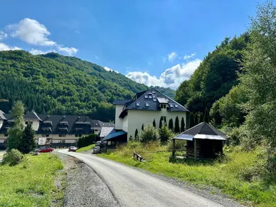 a house on the side of a road next to a mountain at Brzeće - Bele staze Nikola in Brzeće