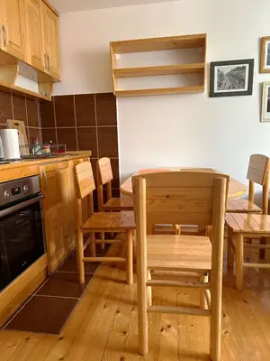 a kitchen with a wooden table and chairs and a table and a table and chairs at Brzeće - Bele staze Nikola in Brzeće
