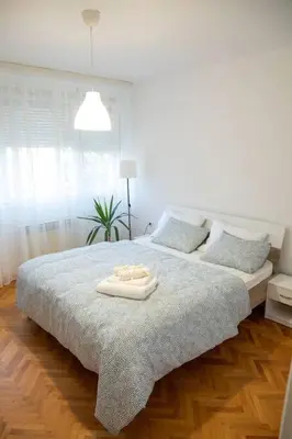 a bedroom with a bed with a tray on it at Dora apartment in Niš