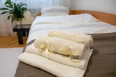 two towels are tied up on a bed at Dora apartment in Niš