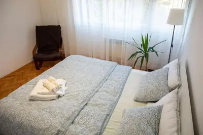 a bedroom with a bed with a towel on it at Dora apartment in Niš
