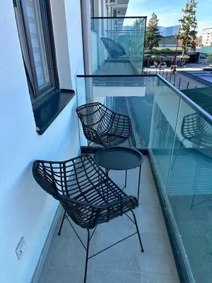 a couple of chairs and a table on a balcony at apartmanjagodinaana in Jagodina