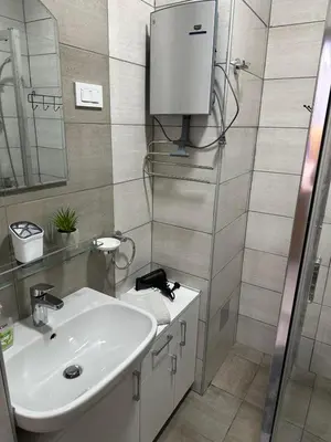 a bathroom with a sink and a mirror at apartmanjagodinaana in Jagodina