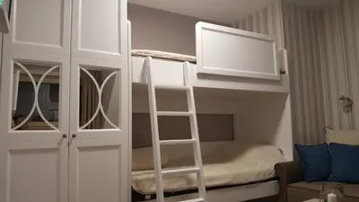 a small room with a bunk bed and a ladder at Apartman Maglic 412 Lux in Kopaonik