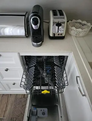 a kitchen counter with a dish drying rack with a toaster at Apartman Maglic 412 Lux in Kopaonik