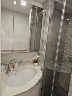 a bathroom with a sink and a shower at Apartman Maglic 412 Lux in Kopaonik
