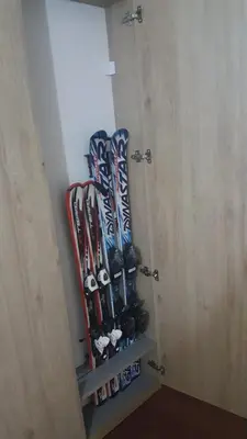a bunch of skis are on a shelf in a room at Apartman Maglic 412 Lux in Kopaonik
