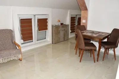 a dining room with a table and chairs at Grof apartmani in Zaječar