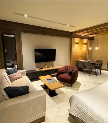 a living room with a couch and a table at Woodside Kopaonik By Gogic in Kopaonik