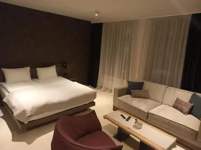 a hotel room with a bed and a couch at Woodside Kopaonik By Gogic in Kopaonik