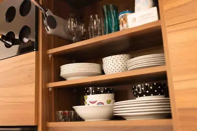 a cabinet filled with plates and bowls and dishes at Apartman W Residence in Kopaonik