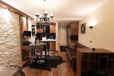 a living room with a couch and a table at Apartman W Residence in Kopaonik