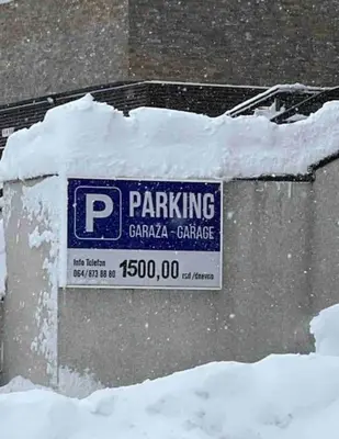 a parking garage sign in a pile of snow at Apartman W Residence in Kopaonik